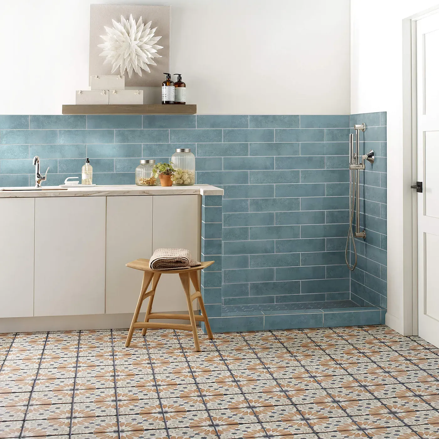 Mint blue subway tile on the wall and multi-colored patterned tile on the floor | Fantastic Floors